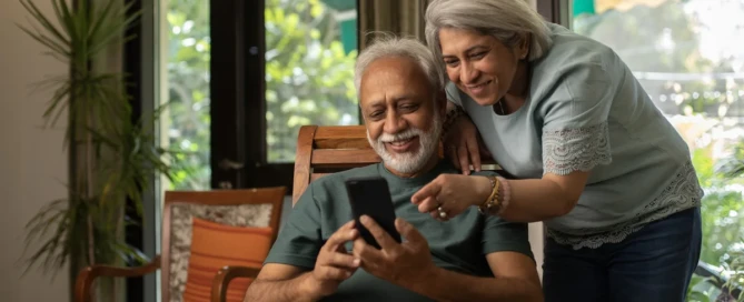 Older couple sitting together smiling in their assisted care apartment at SweetBriar Villa, Springfield, OR.