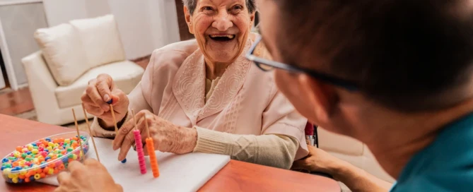 Senior resident engaging in sensory memory activities with Sweetbriar village care team in Springfield Oregon