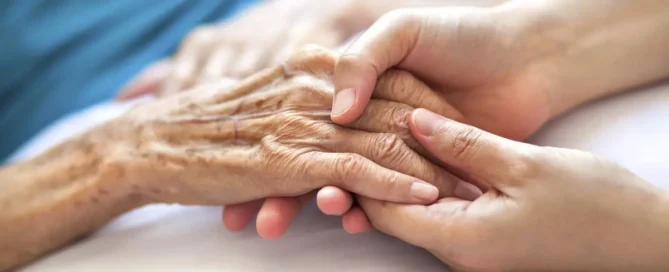 Caregiver offering support to an older adult showing early signs of sundwoning in a senior living community at Sweetbriar Villa